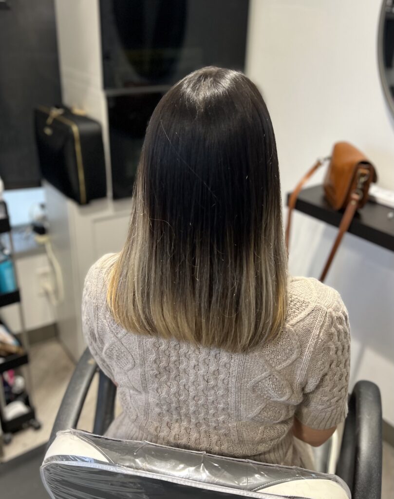 Highlighted blond and black hair reflects Ayda Ghaffari's skill at hair coloring and styling. The straight hair's blunt straight-across chop reflects her skillset with different hair types