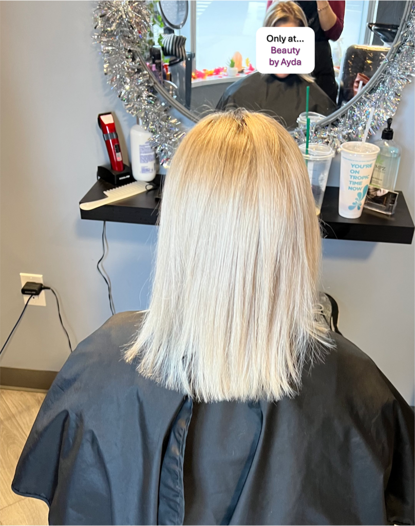 This dyed super blond long bob haircut reflects Ayda Ghaffari's skill at hair coloring and styling. The hair's blunt chop reflects her attention to detail and skill.