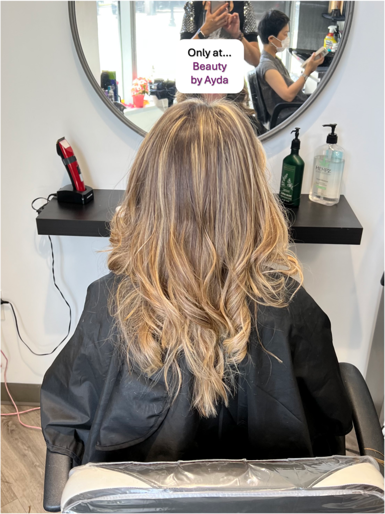 Highlighted hair reflects Ayda Ghaffari's skill at hair coloring and styling. The hair's layering reflects her attention to detail and skill.