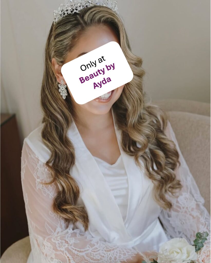 Bride in white with wavy curly hair, freshly highlighted blond showcases Beauty by Ayda's skillset as a hair dresser.